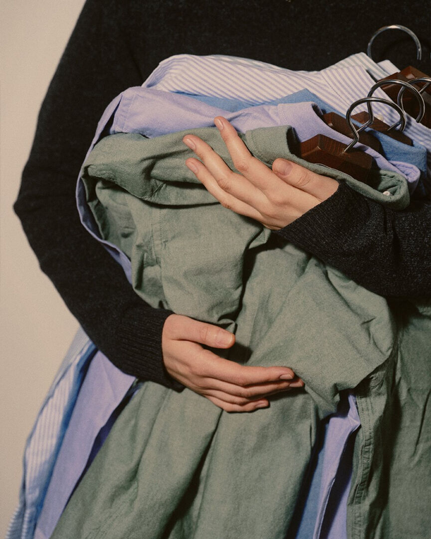Hands holding cotton shirts